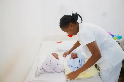 Doctor with twins in Haiti