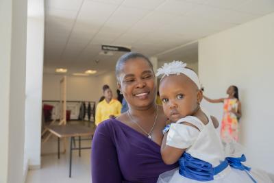 Roselande Germinal and baby Jonara Stécie Saïka Célestin, outside of the conference room at the Mirebalais University Hospital (HUM)